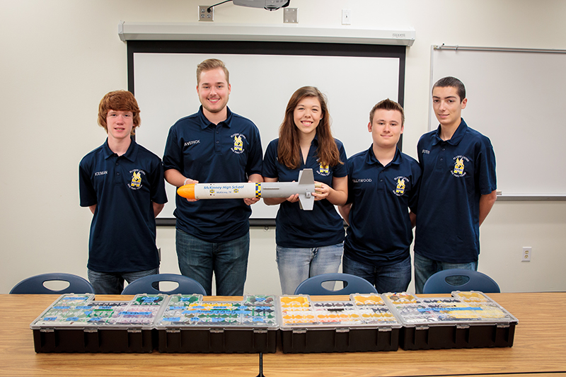 The MHS team holding their 2016 TARC rocket