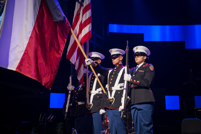 Cadets holding flags on stage