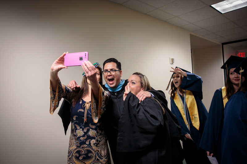 Teachers taking a selfie at graduation