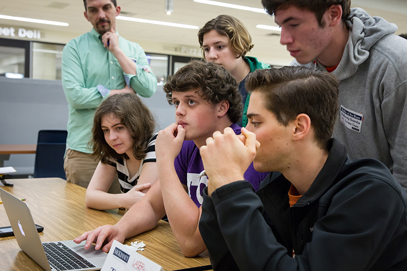 Students gathered around a computer