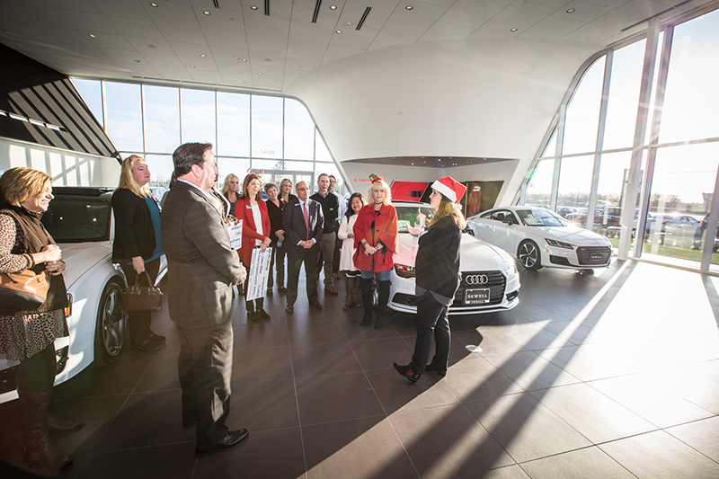 Sine talking to group at Sewell Audi showroom
