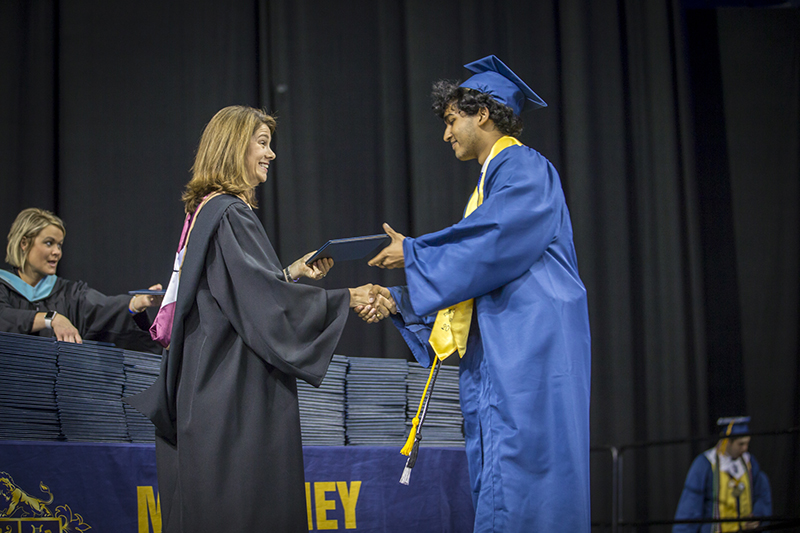 handing diploma and shaking hand