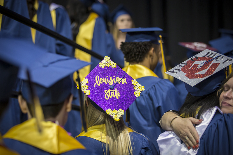 in line, girl with Louisiana State decoration on cap