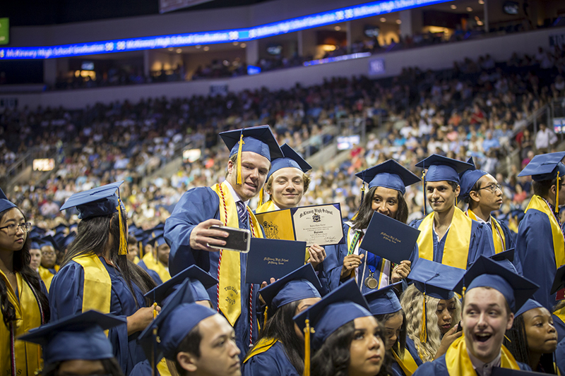 Grads taking a selfie during the ceremony