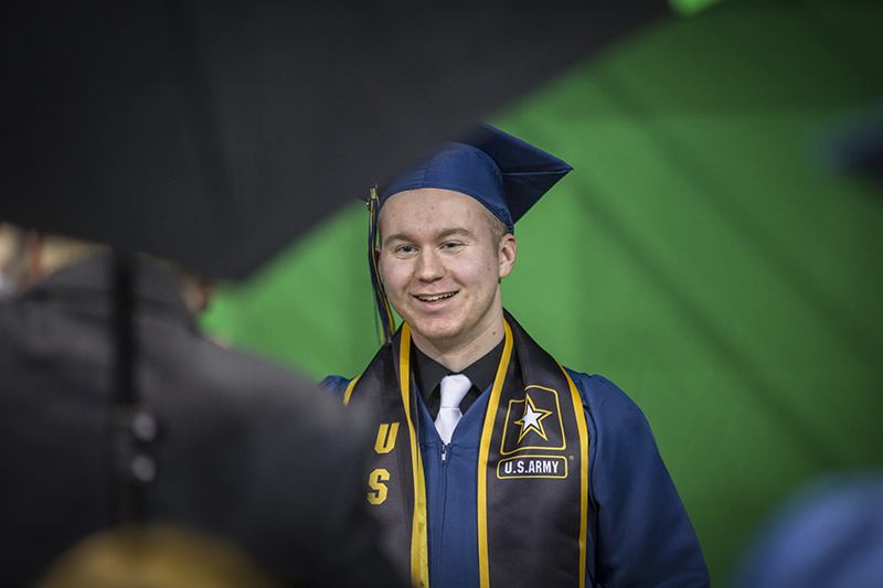 male student in front of green screen for photo