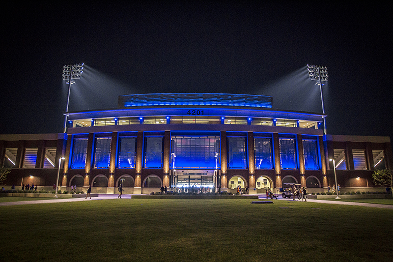 night image outside stadium lit with blue