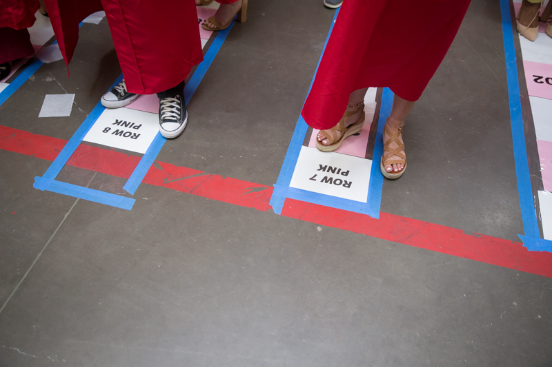 feet standing on rows marked with row designations