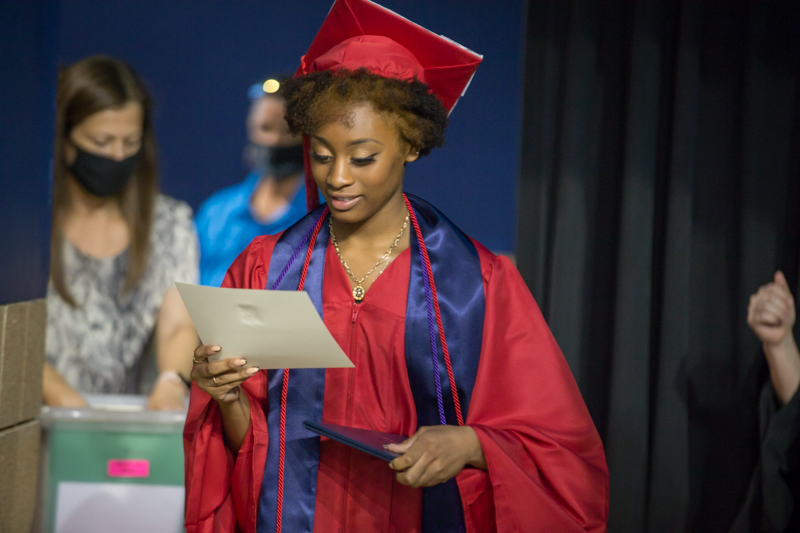 female student looking at diploma
