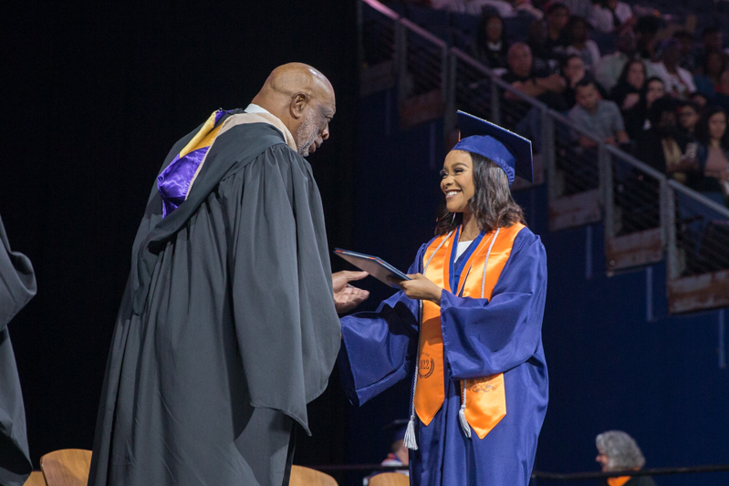 female student receiving diploma from Larry Jagours