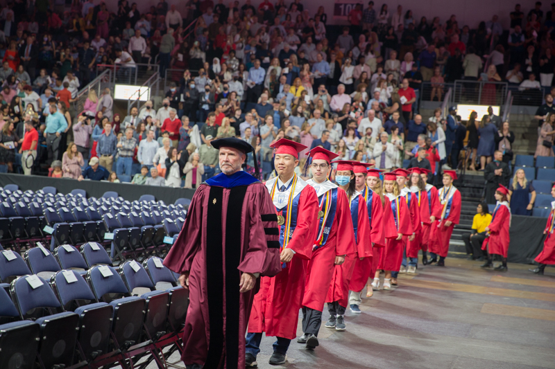graduates walking in to arena