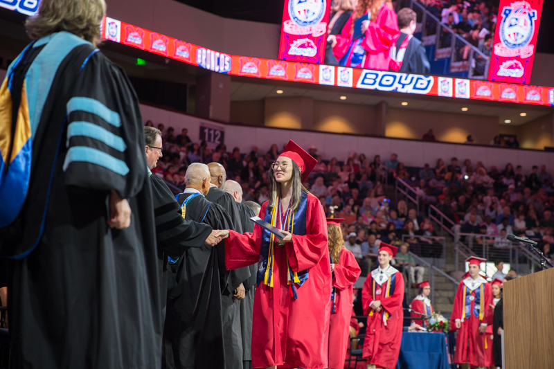 female graduate shaking hands in line onstage