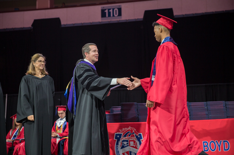 Hassler shaking hands with graduate