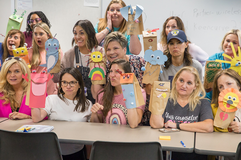 Group of counselors with puppets on hands