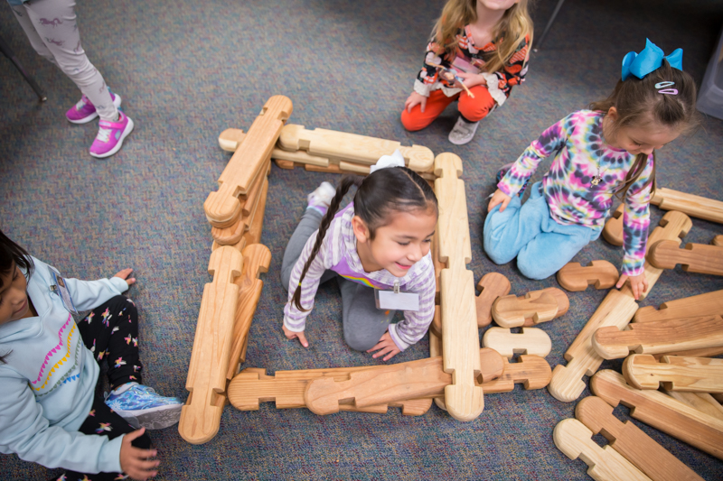 students building with wooden blocks