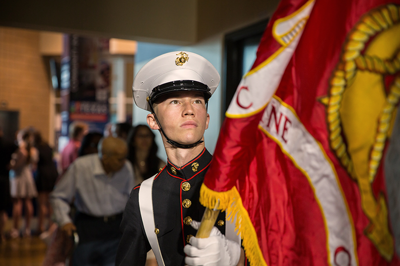 JROTC cadet unrolling a flag