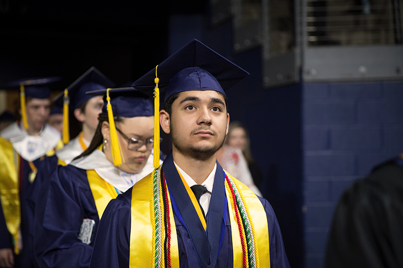 male student in line looking up