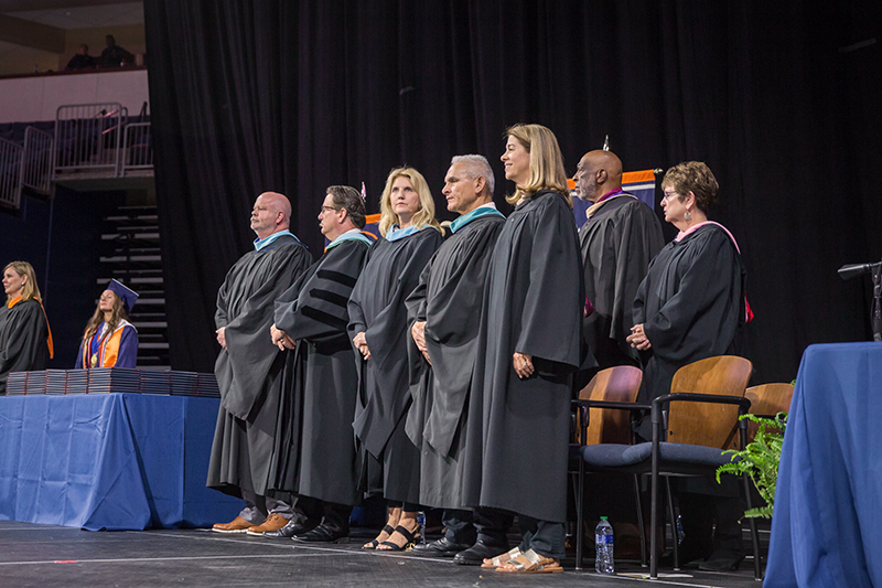 board members standing onstage during processional