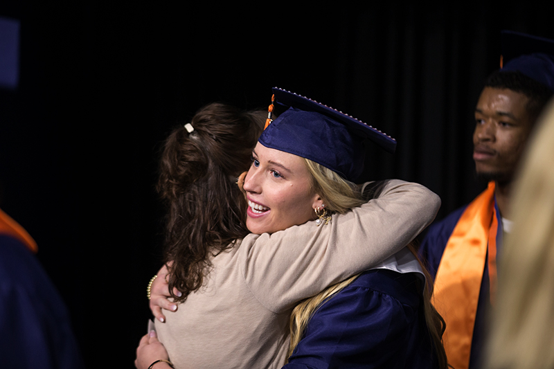 female North student smiling and hugging mom