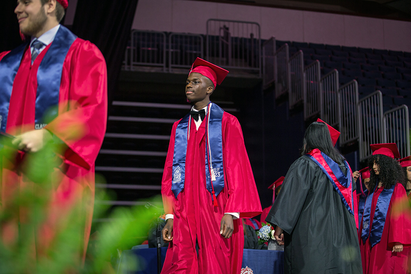 male graduate walking across the stage 
