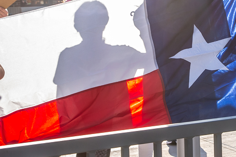 Texas flag with silhouette of student showing through