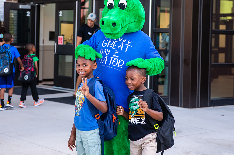 gator mascot with two boys
