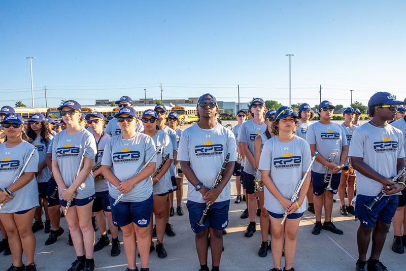 Members of the MHS band stand at attention in the parking lot