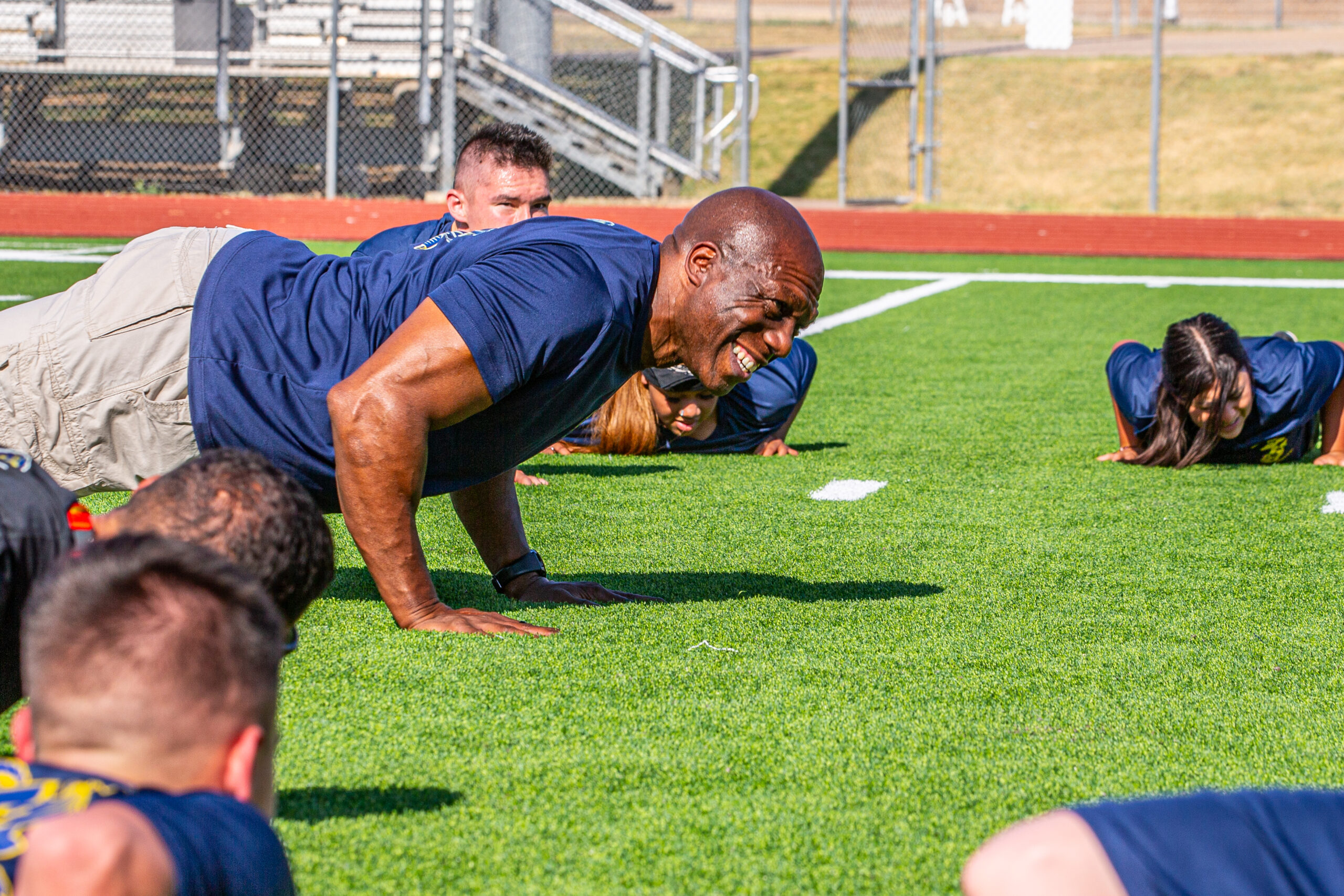 McPhatter smiling and doing pushups with the cadets