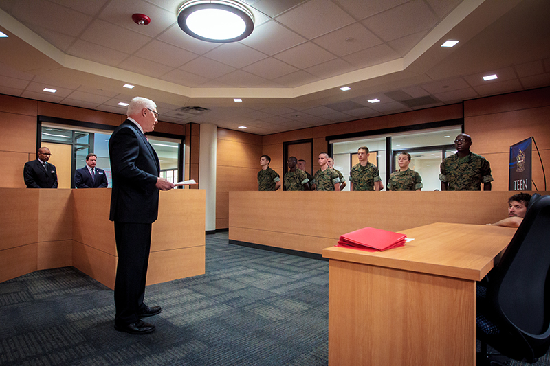 photo in mock courtroom at MHS, colonel wood addressing the cadets