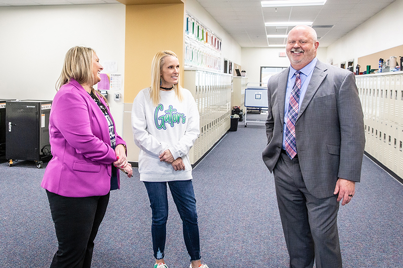 Shelly Spaulding, Principal Amy Holderman and Superintendent Shawn Pratt sharing a laugh in the hallway