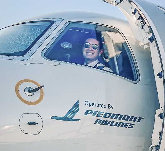 Rensing looking out of the cockpit window of Piedmont commercial airliner